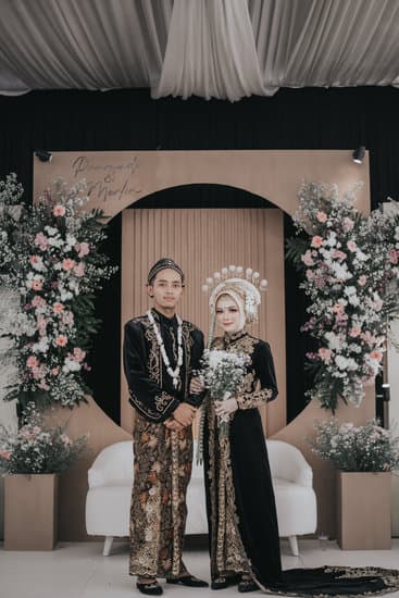 Do You Say Happy Anniversary or Happy Wedding Anniversary 13 Happy Wedding Anniversary - A couple holding hands and smiling under a romantic sunset