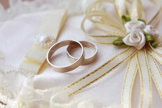 Smiling bride and groom in formal attire outdoors