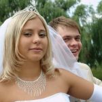 How Do You Put Your Wedding Ring On Engraved wedding ring being delicately placed on a finger - How do you put your wedding ring on