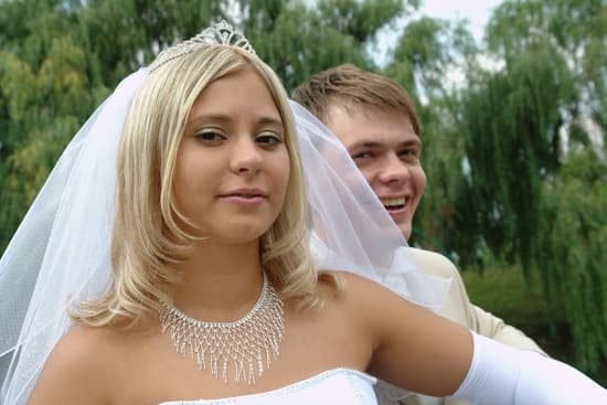 How Do You Put Your Wedding Ring On 1 Engraved wedding ring being delicately placed on a finger - How do you put your wedding ring on
