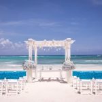 Identify which side is bride at wedding with clear signage near entrance