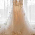 Stunning bride in a white gown, exchanging vows under a garden gazebo